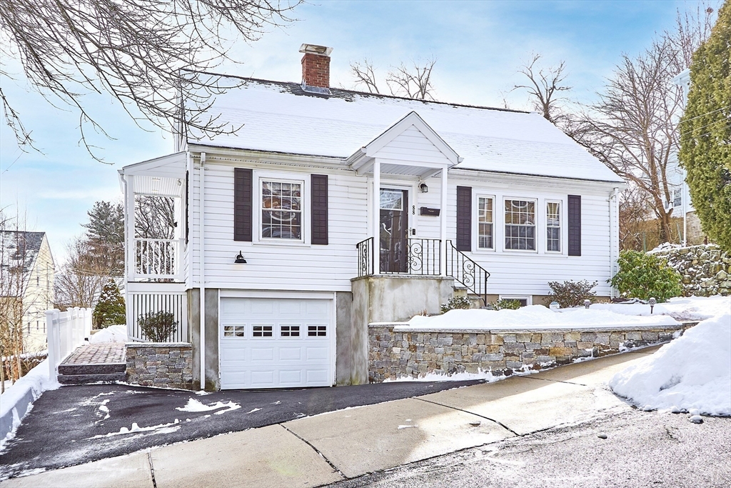 88 Menotomy Road Arlington, MA 02476 - Photo 2 of 40 a front view of a house with a yard and garage