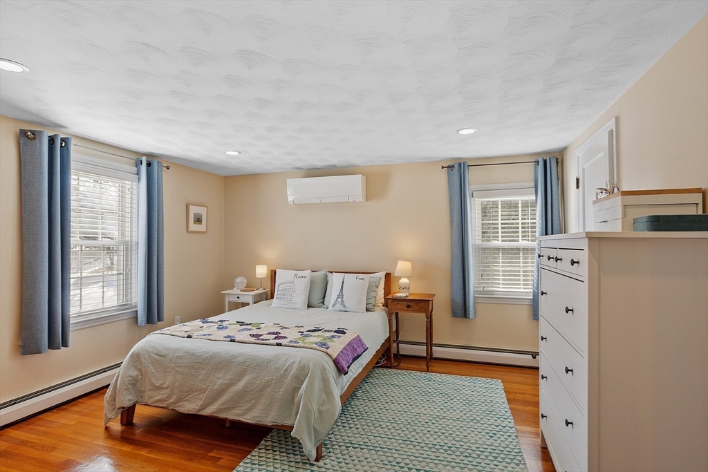 88 Menotomy Road Arlington, MA 02476 - Photo 22 of 40 a bedroom with a bed and wooden floor