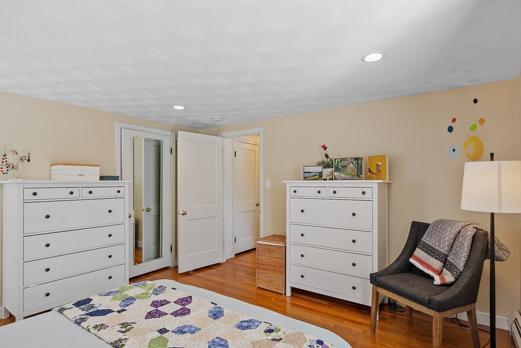 88 Menotomy Road Arlington, MA 02476 - Photo 23 of 40 a bedroom with a dresser and a mirror