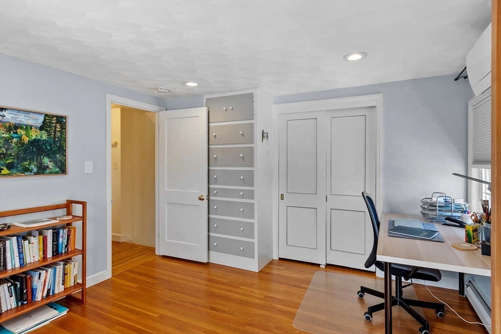 88 Menotomy Road Arlington, MA 02476 - Photo 25 of 40 a room with furniture and a book shelf