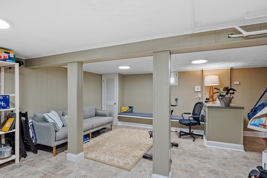 88 Menotomy Road Arlington, MA 02476 - Photo 29 of 40 a living room with furniture and a dining table with wooden floor