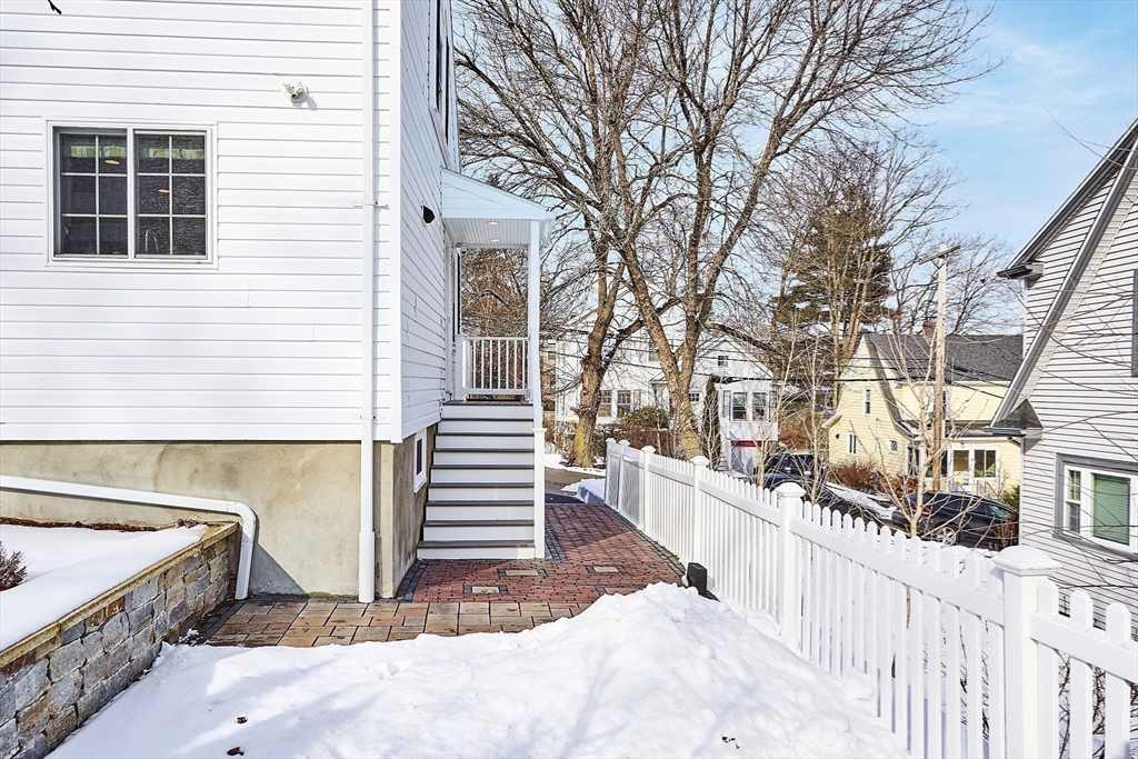 88 Menotomy Road Arlington, MA 02476 - Photo 32 of 40 a view of a wooden house with a large window and wooden fence