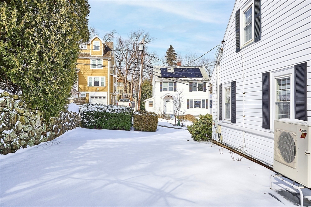 88 Menotomy Road Arlington, MA 02476 - Photo 33 of 40 a front view of a house with garden