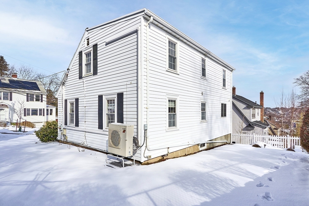88 Menotomy Road Arlington, MA 02476 - Photo 34 of 40 a view of a house with a barbeque and wooden fence