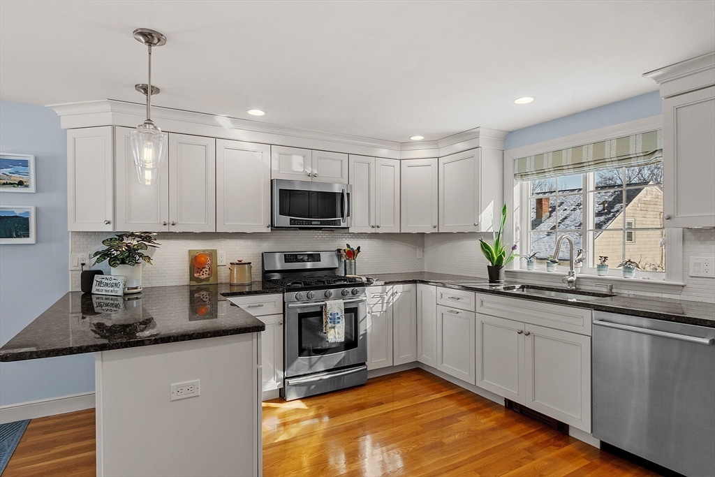 88 Menotomy Road Arlington, MA 02476 - Photo 4 of 40 a kitchen with stainless steel appliances granite countertop a sink a stove top oven a counter space and cabinets