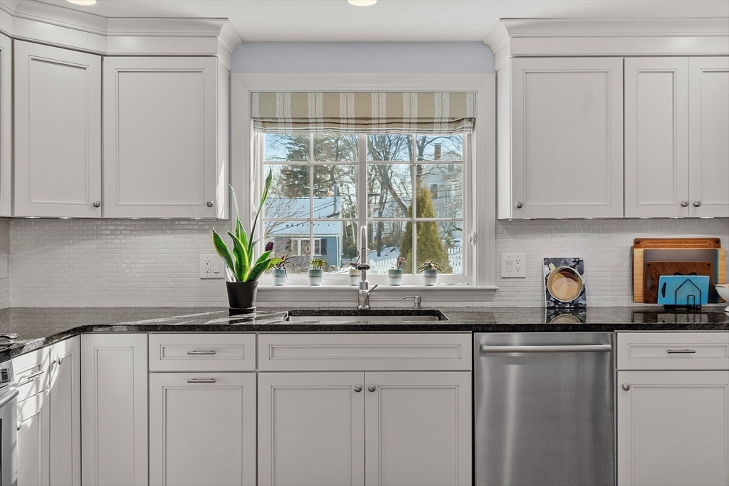 88 Menotomy Road Arlington, MA 02476 - Photo 7 of 40 a kitchen with stainless steel appliances white cabinets and a granite counter tops