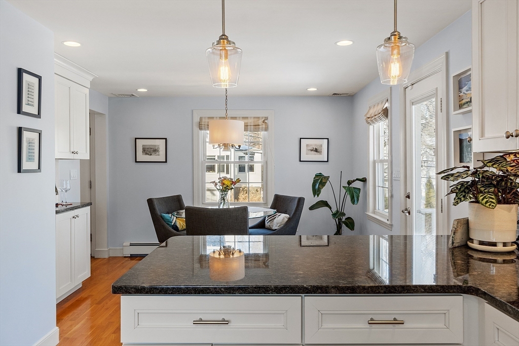 88 Menotomy Road Arlington, MA 02476 - Photo 8 of 40 a kitchen with a refrigerator a sink and white cabinets