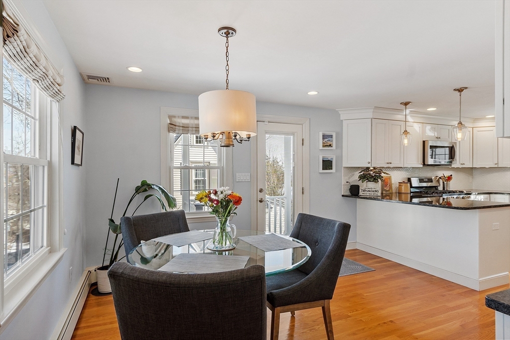 88 Menotomy Road Arlington, MA 02476 - Photo 9 of 40 a view of a dining room and livingroom with furniture wooden floor a chandelier
