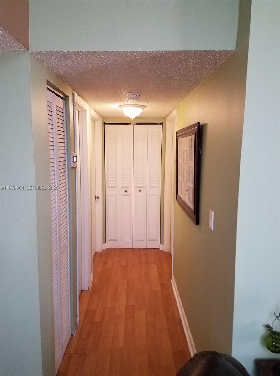 8500 Southwest 133rd Avenue Road, Unit 108 Miami, FL 33183 - Photo 11 of 17 a view of a hallway with wooden floor
