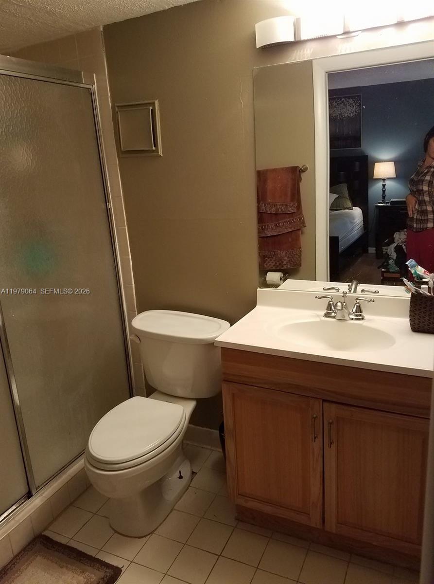 8500 Southwest 133rd Avenue Road, Unit 108 Miami, FL 33183 - Photo 15 of 17 a bathroom with a sink toilet and mirror