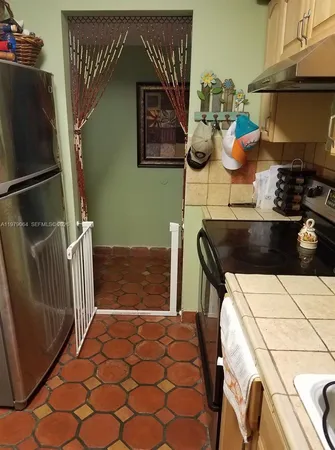 a kitchen with a refrigerator and a stove