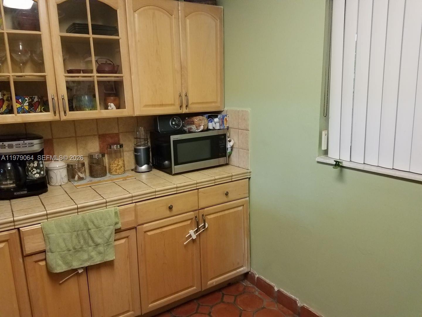 8500 Southwest 133rd Avenue Road, Unit 108 Miami, FL 33183 - Photo 7 of 17 a close up of a microwave and utility room