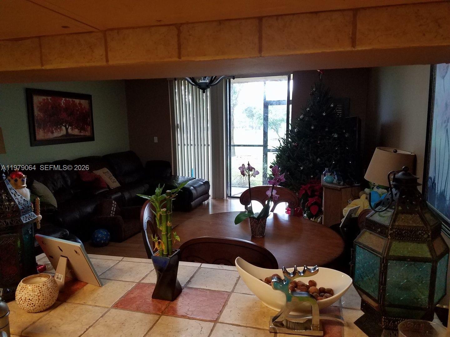 8500 Southwest 133rd Avenue Road, Unit 108 Miami, FL 33183 - Photo 8 of 17 a living room with furniture and flowers