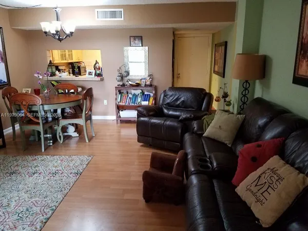 a living room with furniture a dining table and a fireplace