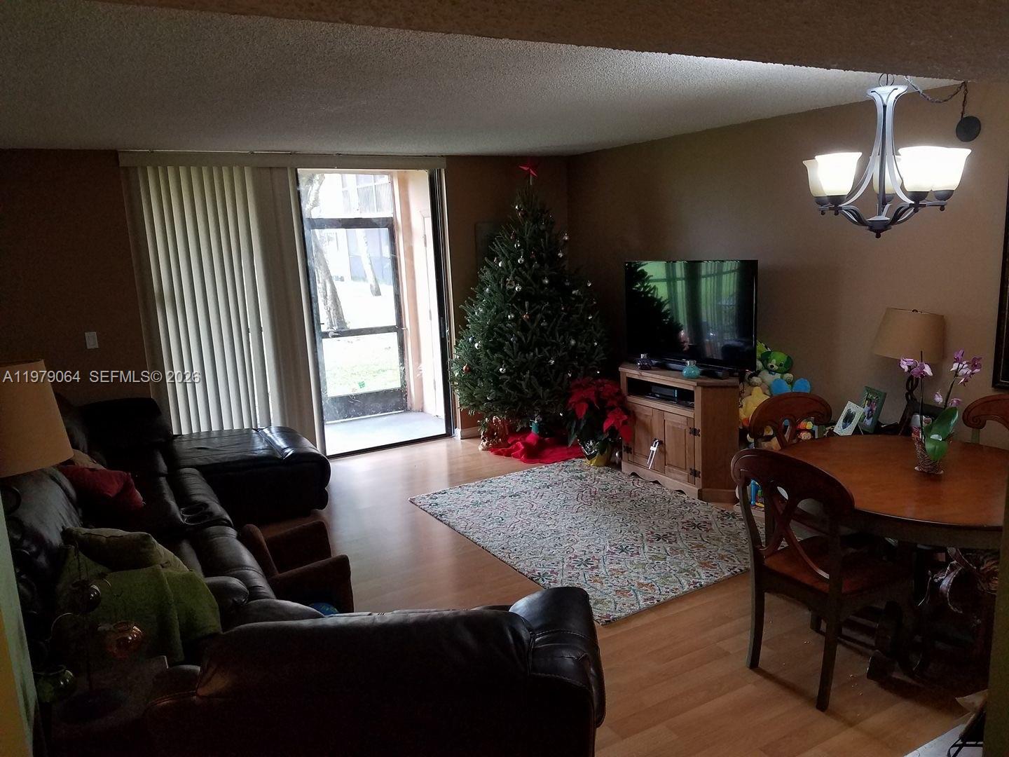8500 Southwest 133rd Avenue Road, Unit 108 Miami, FL 33183 - Photo 10 of 17 a living room with furniture and a window