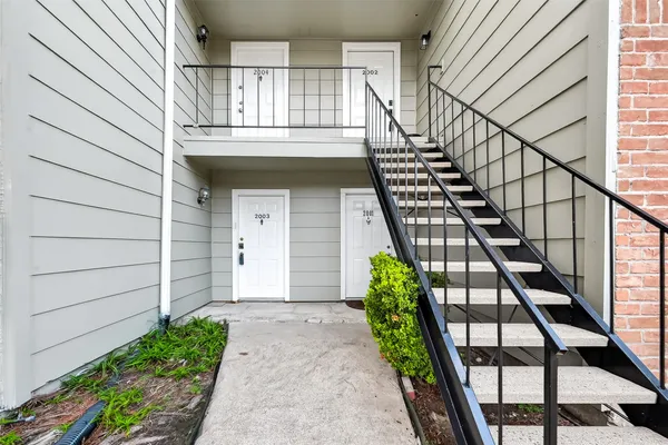 a view of front door with wooden stairs