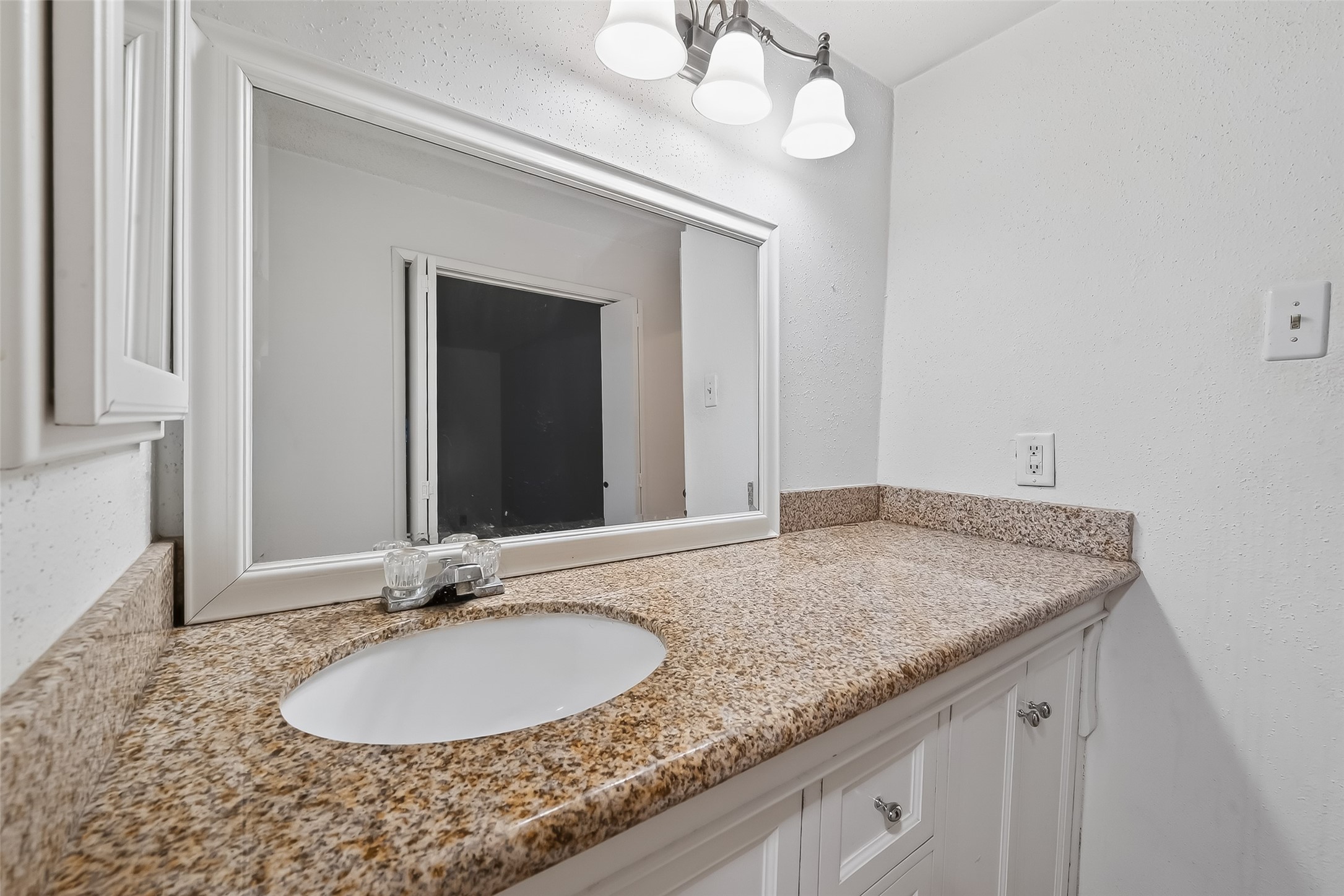 2800 Jeanetta Street, Unit 2003 Houston, TX 77063 - Photo 20 of 24 a bathroom with a granite countertop sink and a mirror