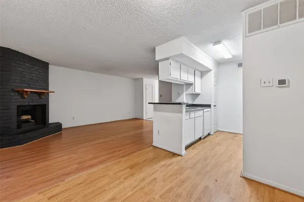 a kitchen with granite countertop a refrigerator and a stove