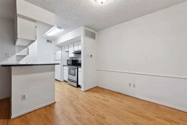 a kitchen with stainless steel appliances a refrigerator and a stove top oven