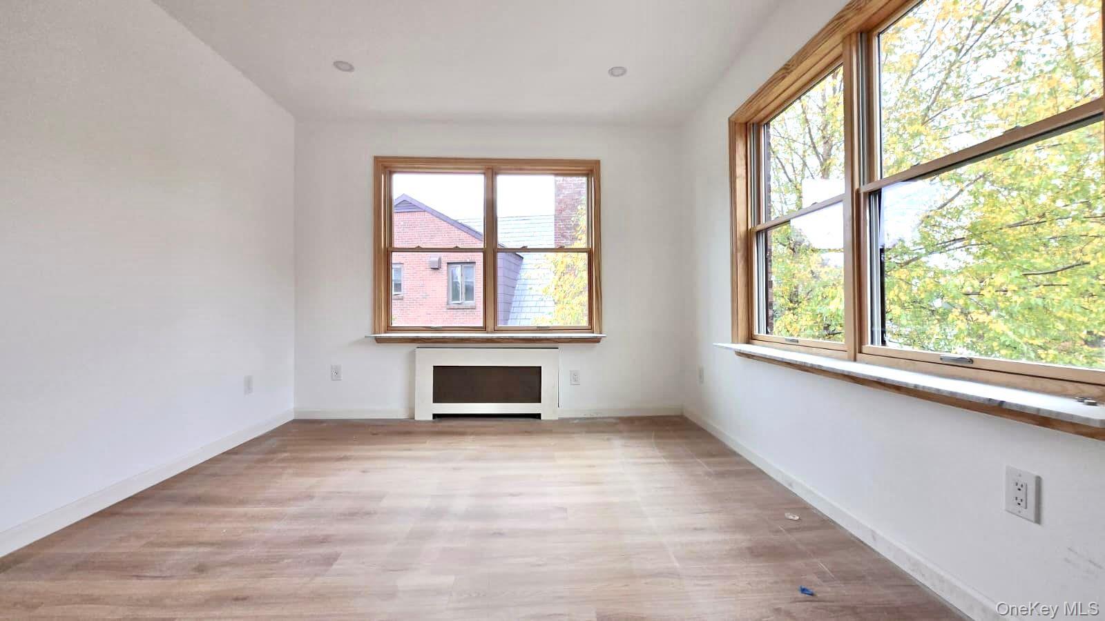 63-87 Fitchett Street, Unit 2 Queens, NY 11374 - Photo 8 of 12 an empty room with windows