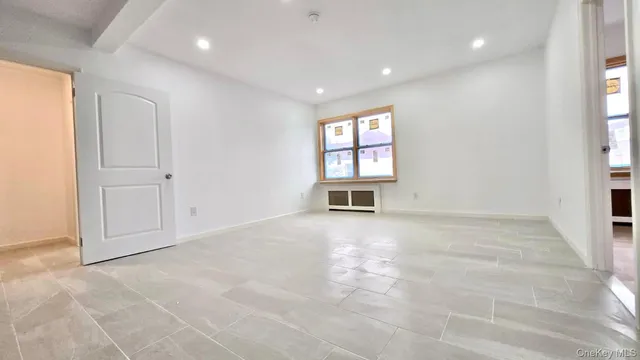 an empty room with windows and pillars in it