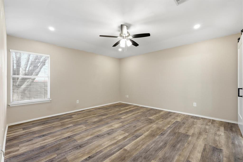 7733 Liz Lane Watauga, TX 76148 - Photo 15 of 27 Spare room featuring light wood-style floors, ceiling fan, and recessed lighting