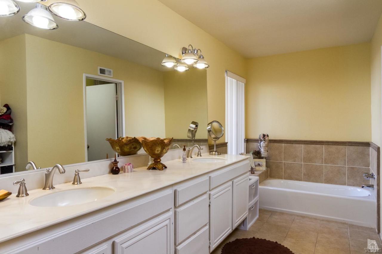 12685 Crystal Ranch Road Moorpark, CA 93021 - Photo 17 of 25 a bathroom with a double vanity sink a mirror and a bathtub