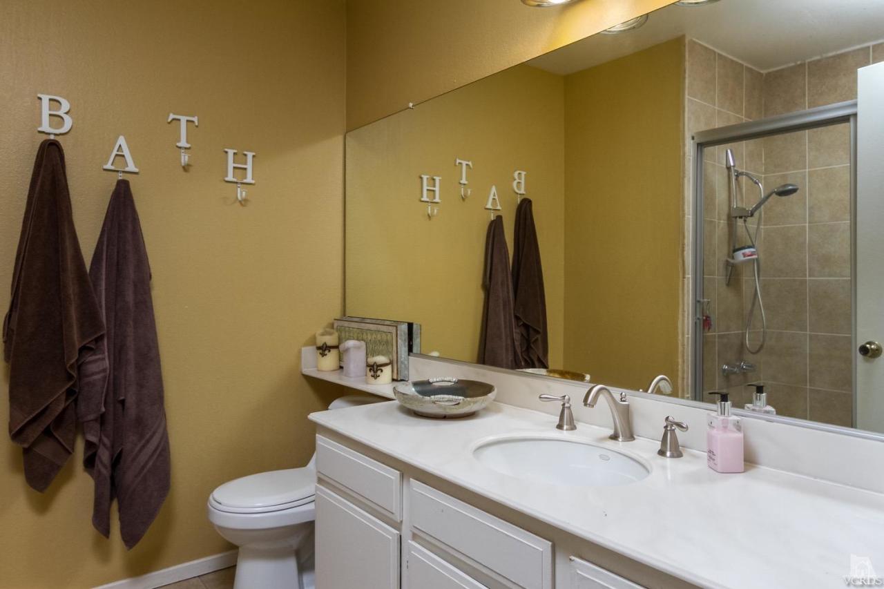 12685 Crystal Ranch Road Moorpark, CA 93021 - Photo 20 of 25 a bathroom with a granite countertop sink toilet and shower