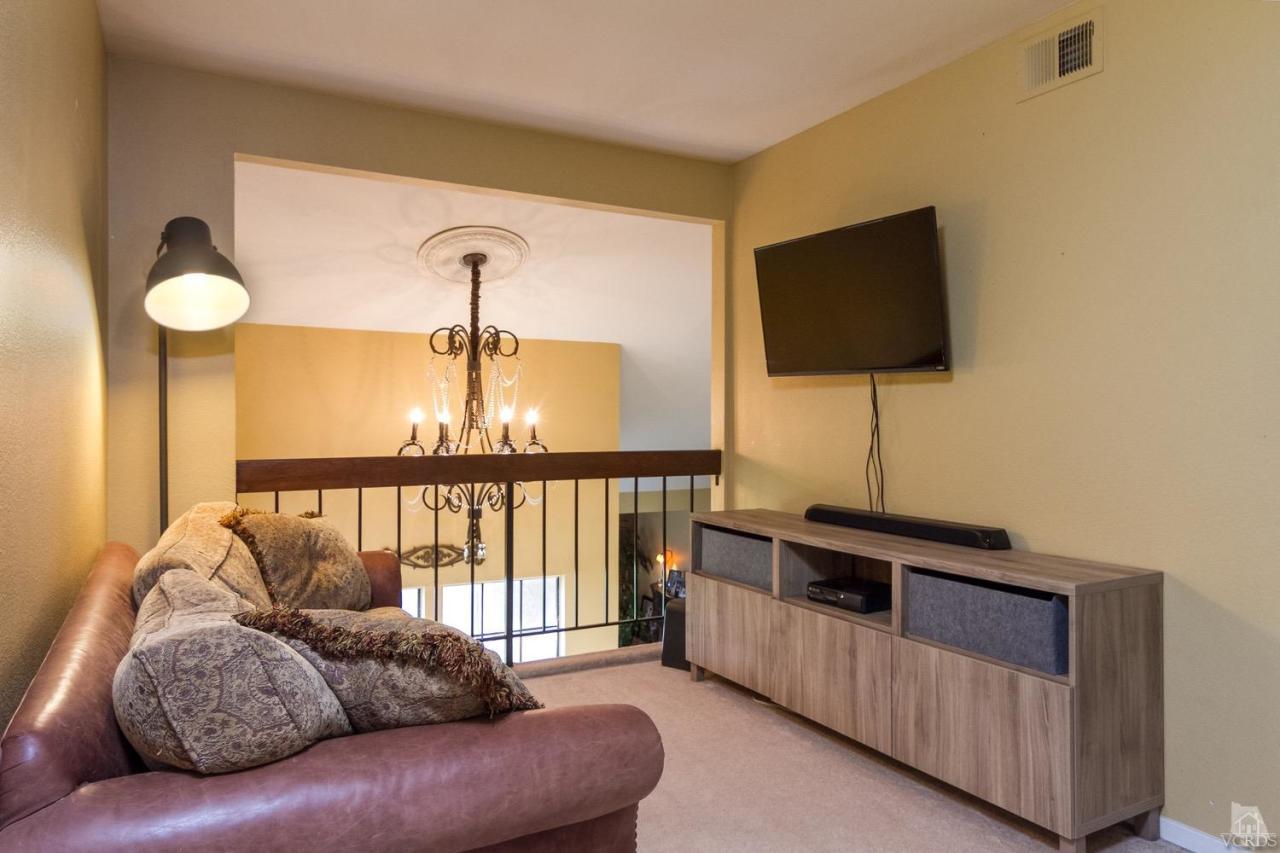 12685 Crystal Ranch Road Moorpark, CA 93021 - Photo 21 of 25 a living room with furniture and a flat screen tv