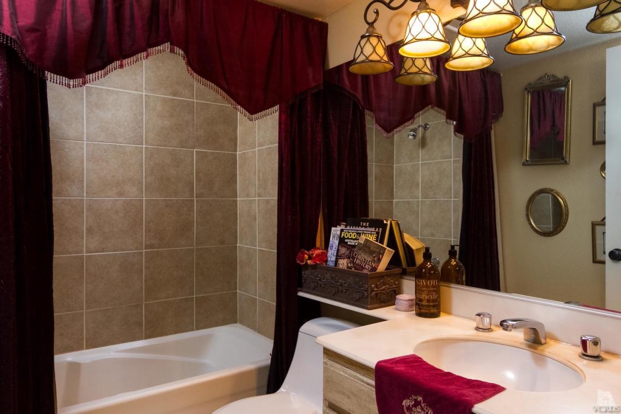 12685 Crystal Ranch Road Moorpark, CA 93021 - Photo 22 of 25 a bathroom with a sink vanity and a mirror