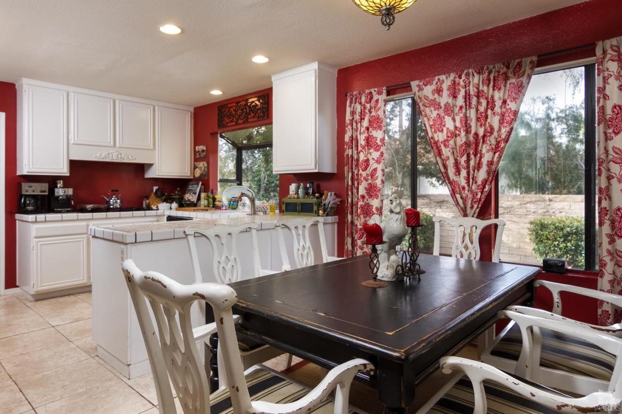 12685 Crystal Ranch Road Moorpark, CA 93021 - Photo 10 of 25 a kitchen with a dining table chairs and a counter top space