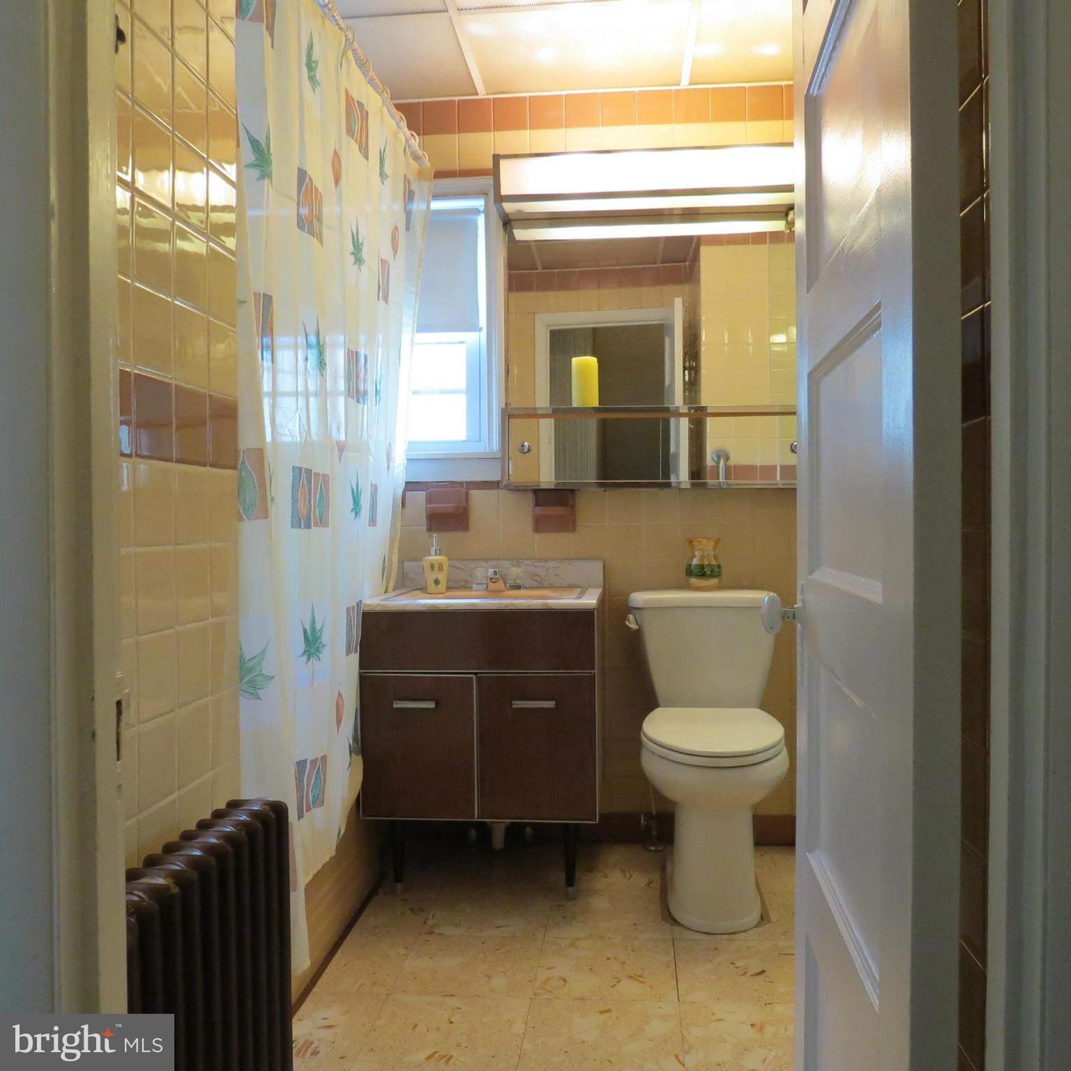 17 Township Road Dundalk, MD 21222 - Photo 17 of 25 a bathroom with a granite countertop toilet a sink and a mirror