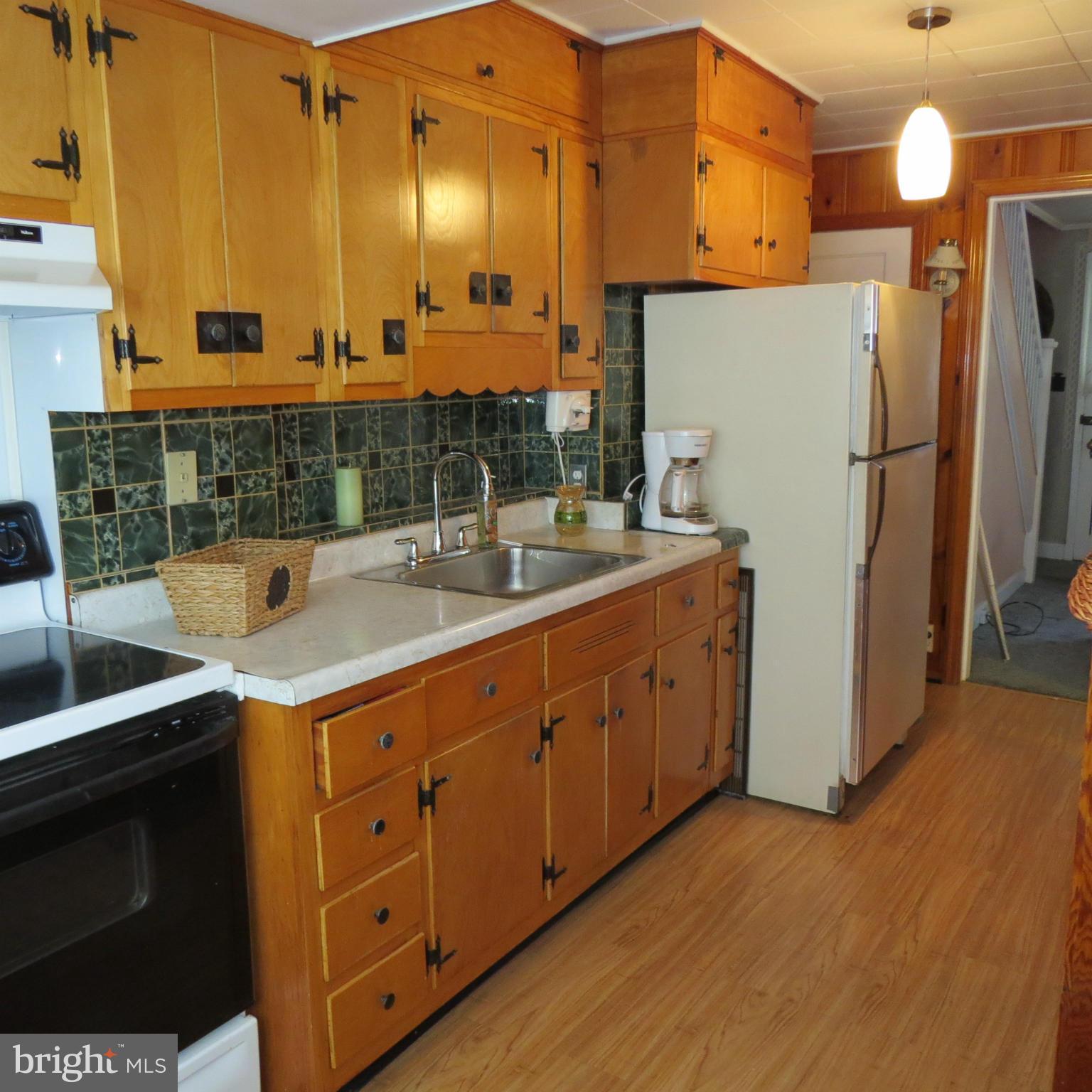 17 Township Road Dundalk, MD 21222 - Photo 3 of 25 a kitchen with cabinets a refrigerator and a sink
