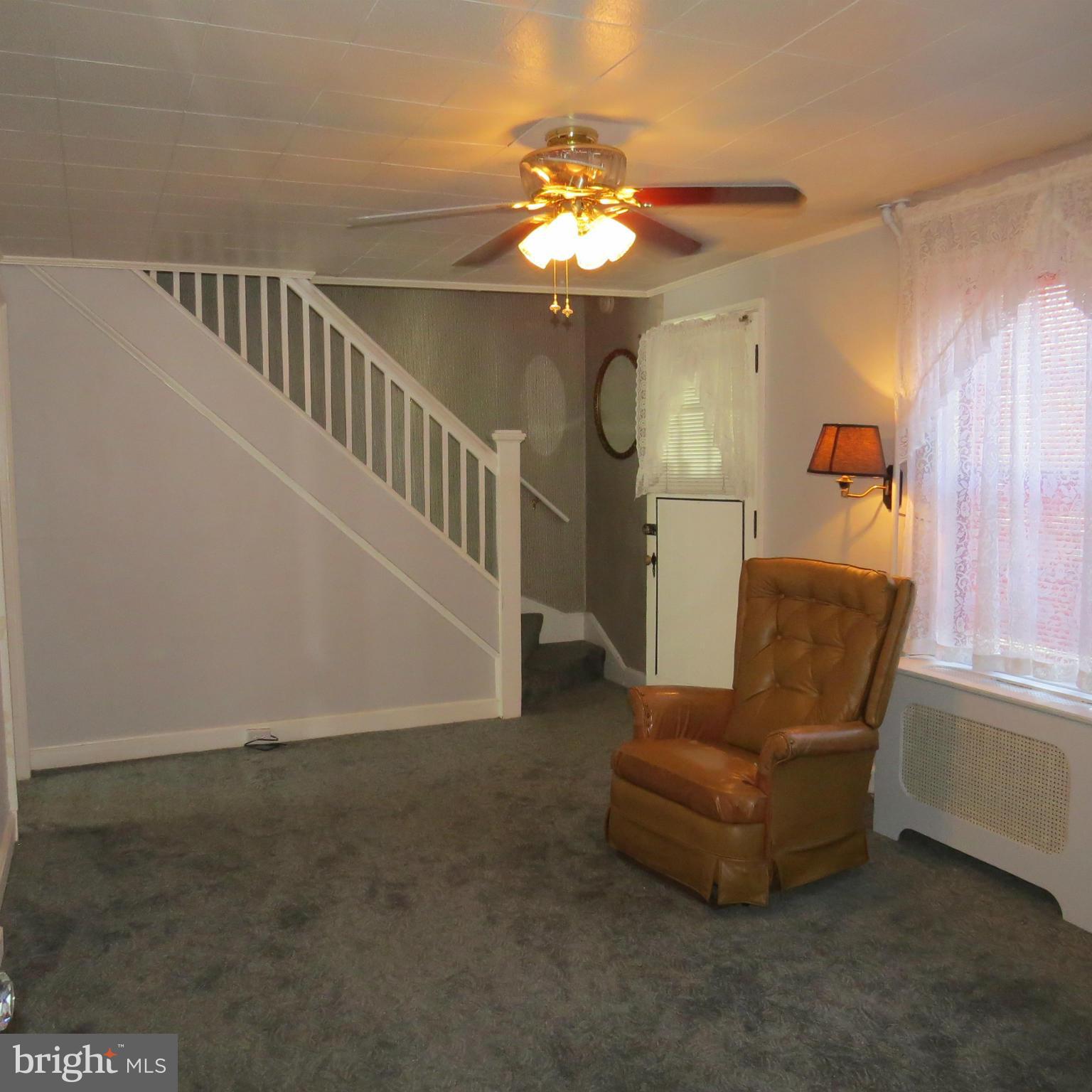 17 Township Road Dundalk, MD 21222 - Photo 4 of 25 a living room with furniture and a chandelier