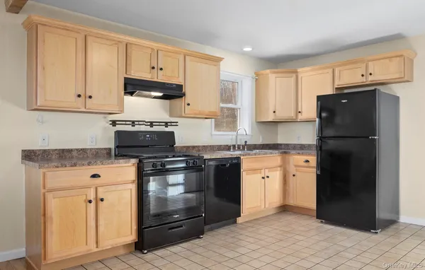 a kitchen with granite countertop cabinets and steel stainless steel appliances
