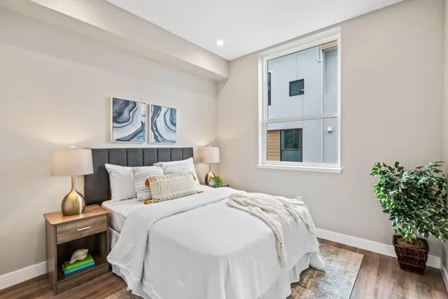 a bedroom with bed and a potted plant