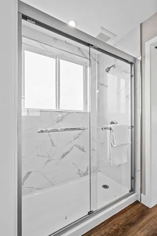 a bathroom with a glass shower door