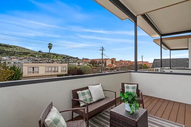 a view of a balcony with chairs