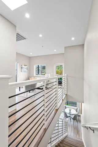 a kitchen with a sink stainless steel appliances furniture and view living room