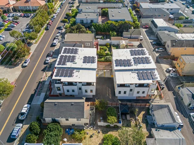an aerial view of residential houses with outdoor space