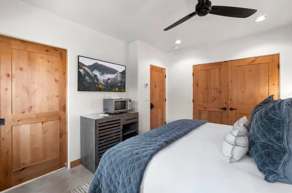 a bedroom with a bed and a chandelier