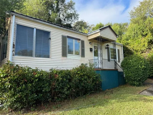 a view of house with backyard