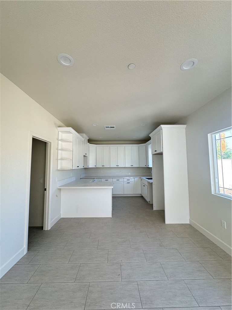 191 East O Street Colton, CA 92324 - Photo 13 of 27 a view of a kitchen with wooden cabinet and a refrigerator
