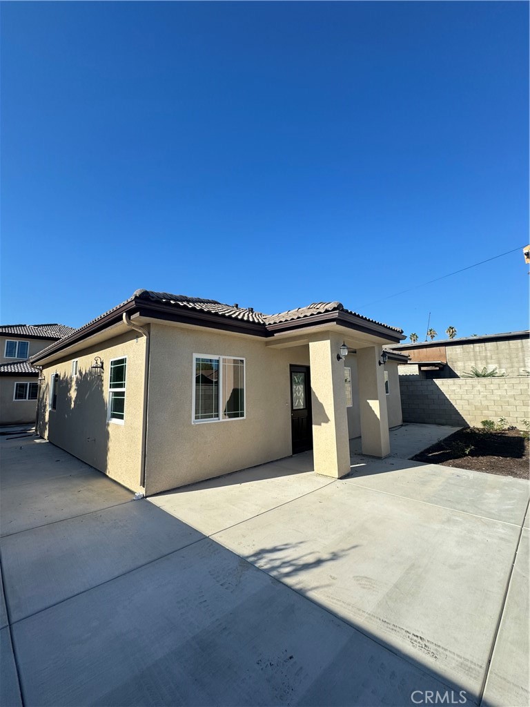 191 East O Street Colton, CA 92324 - Photo 15 of 27 a view of a house with a backyard