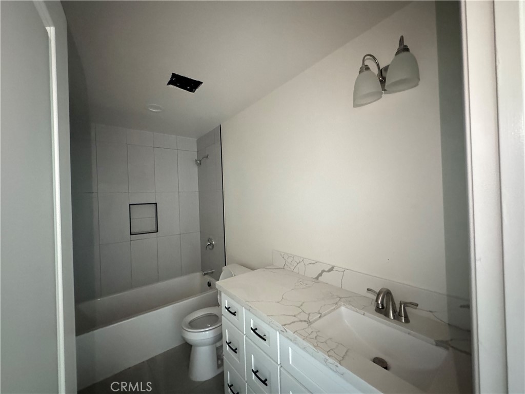 191 East O Street Colton, CA 92324 - Photo 19 of 27 a bathroom with a sink toilet and shower