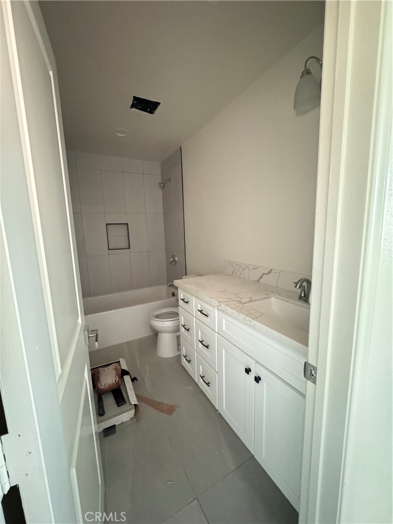 191 East O Street Colton, CA 92324 - Photo 20 of 27 a bathroom with a tub sink vanity granite and toilet
