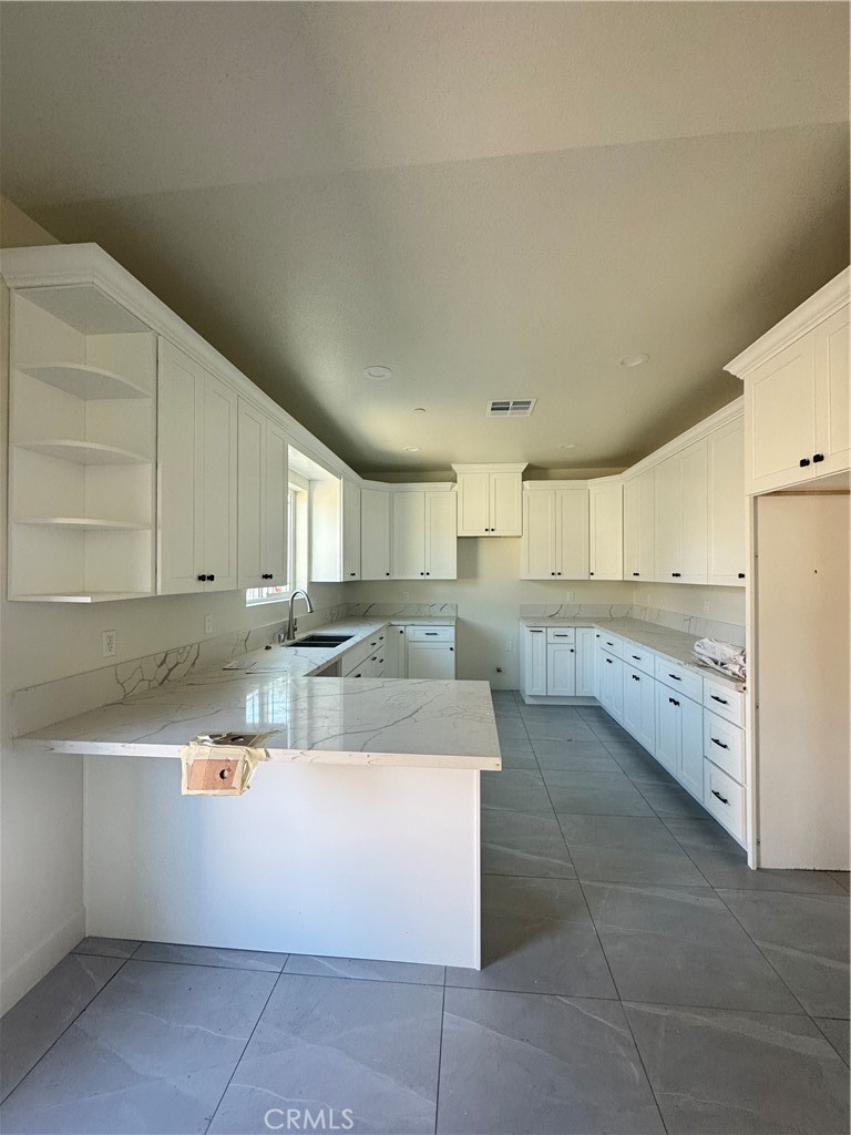 191 East O Street Colton, CA 92324 - Photo 24 of 27 a large bathroom with a large tub and cabinets