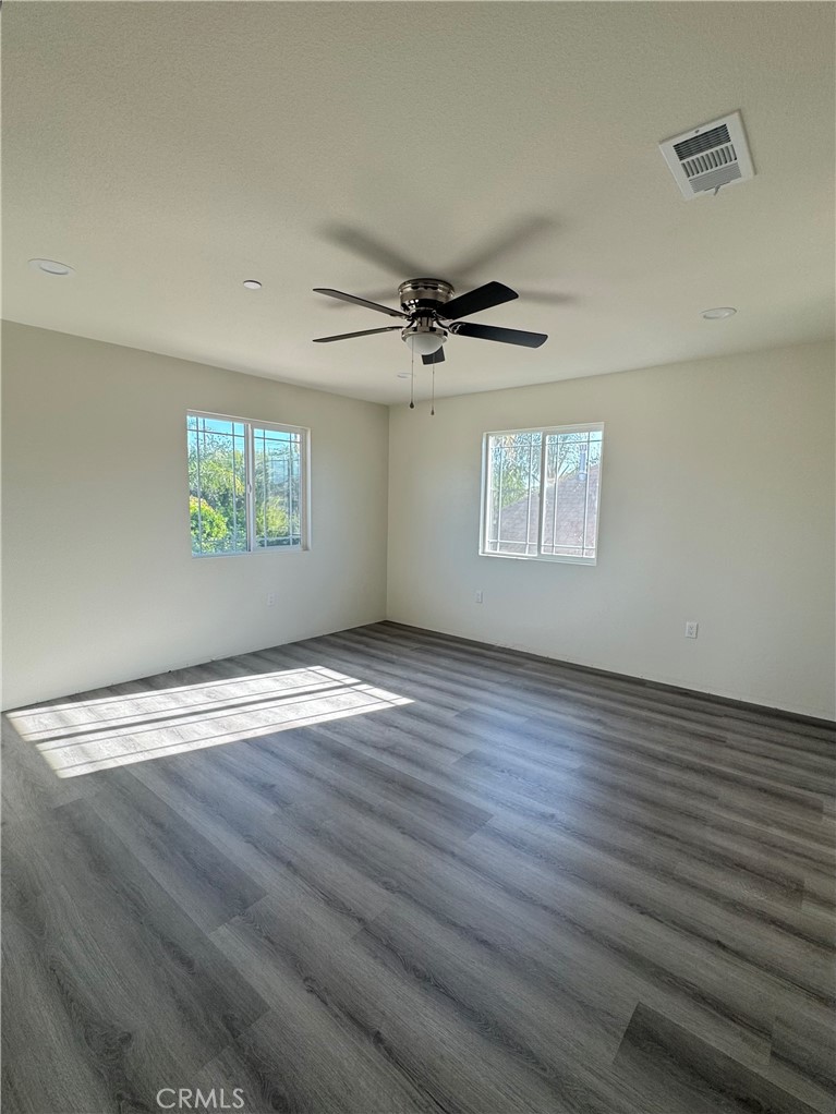 191 East O Street Colton, CA 92324 - Photo 26 of 27 an empty room with wooden floor and windows