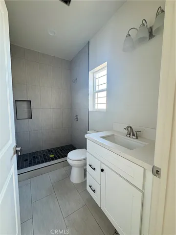 a bathroom with a sink toilet and window