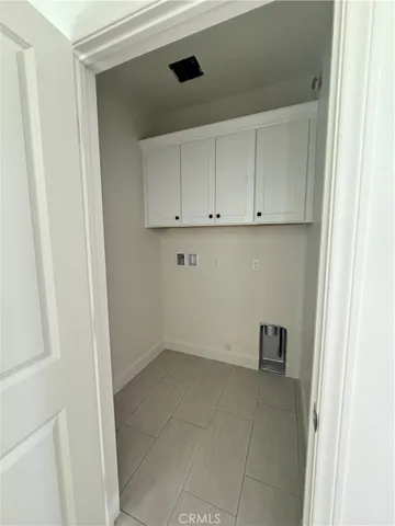 a view of kitchen with white cabinets